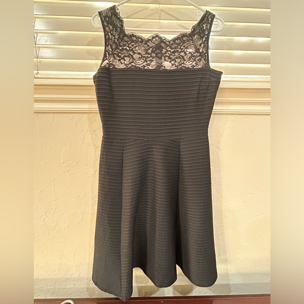 Beautiful feminine little black dress with lace top and boat neck